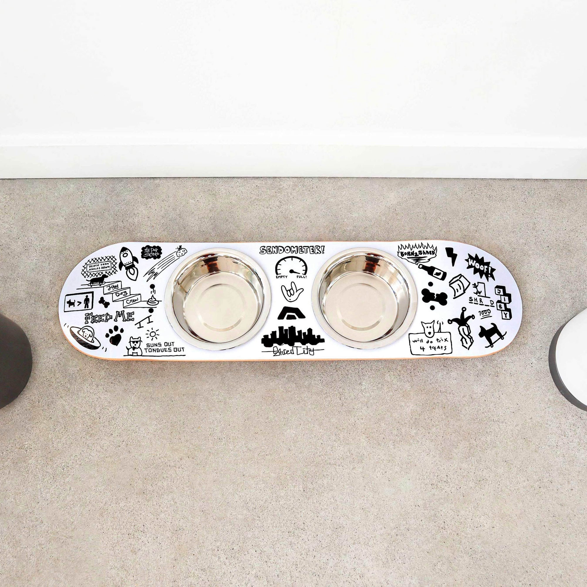 French bulldog eating from a handcrafted skateboard dog bowl feeder stand