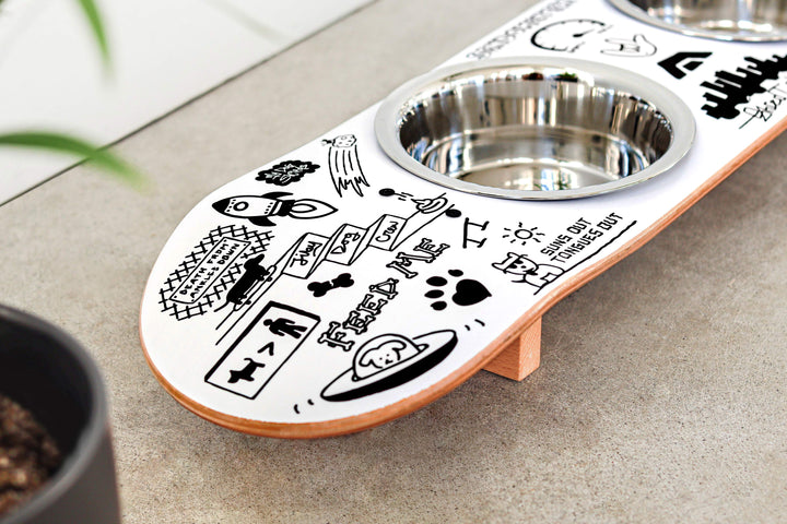 French bulldog eating from a handcrafted skateboard dog bowl feeder stand