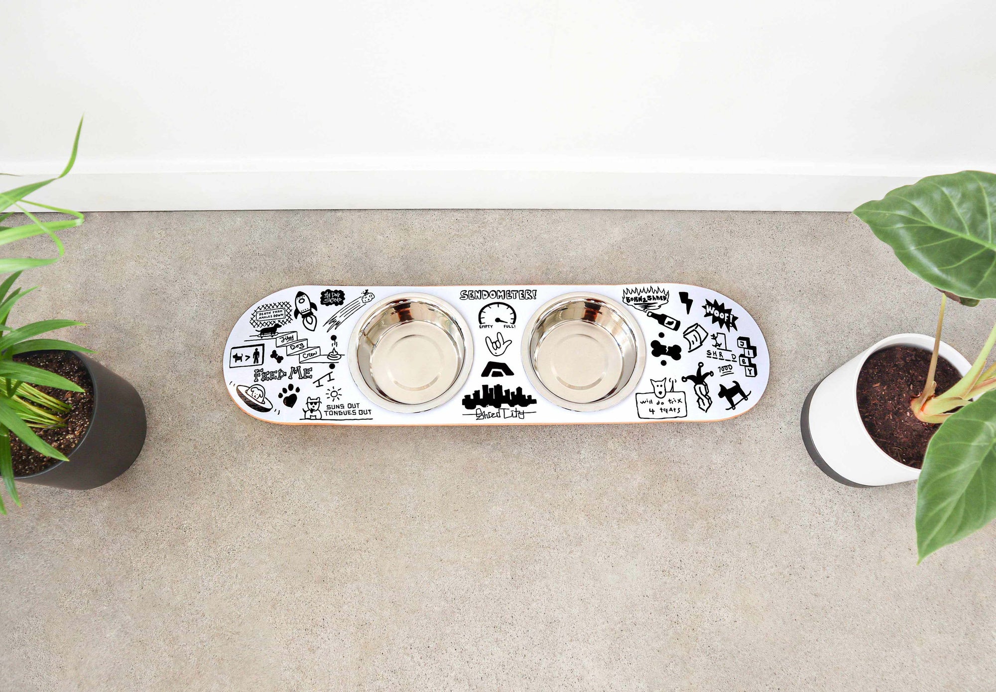 French bulldog eating from a handcrafted skateboard dog bowl feeder stand