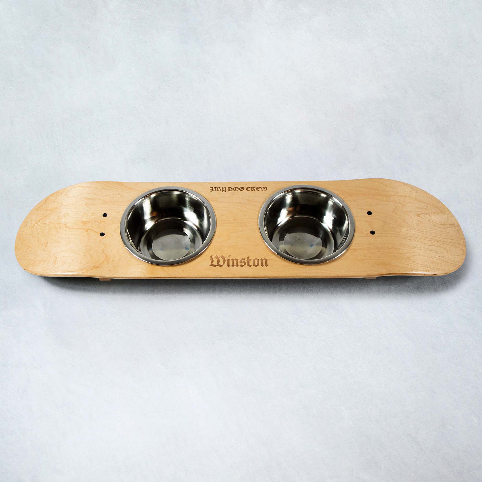 Skateboard dog bowl feeder stand handcrafted with custom designed art.