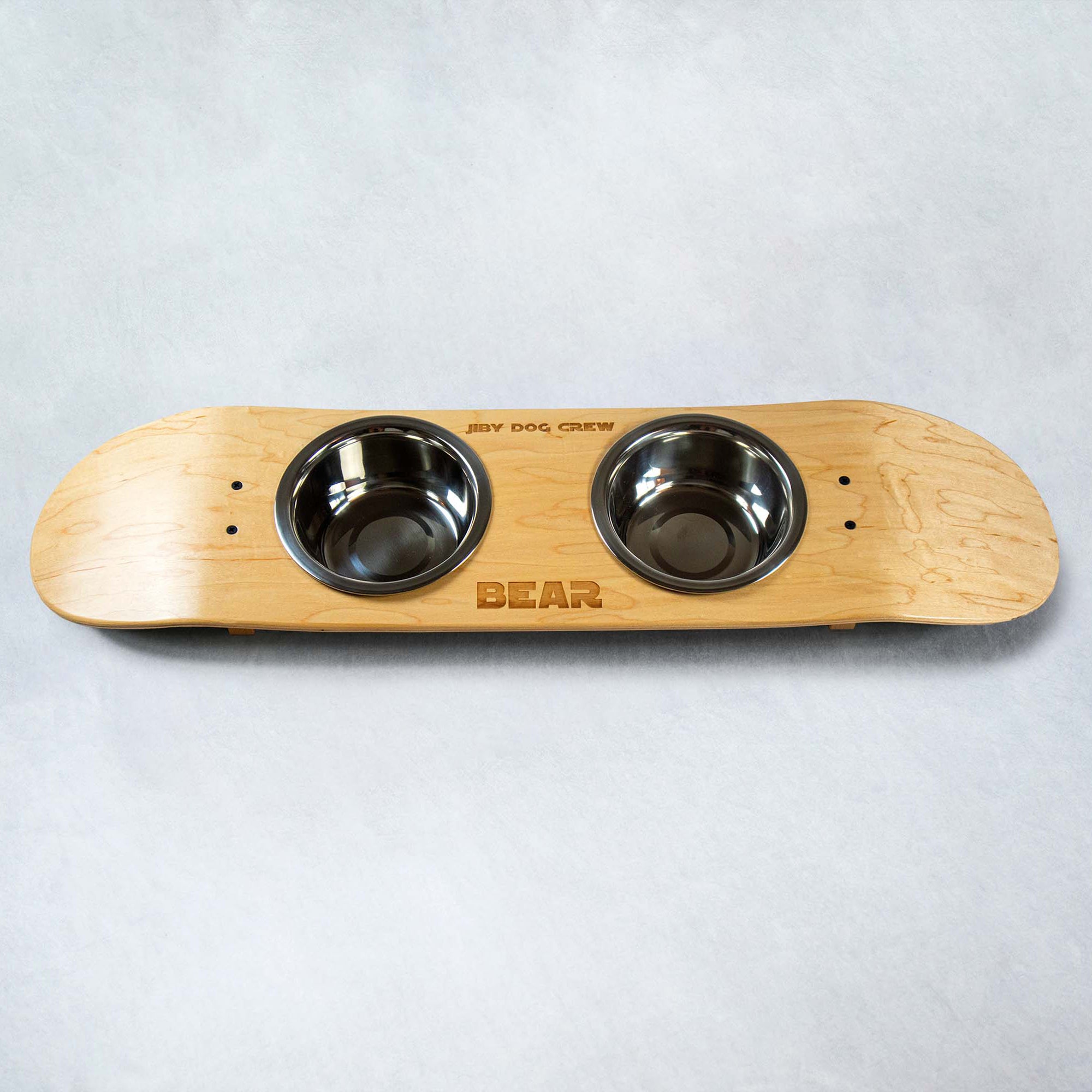 Skateboard dog bowl feeder stand handcrafted with custom designed art.