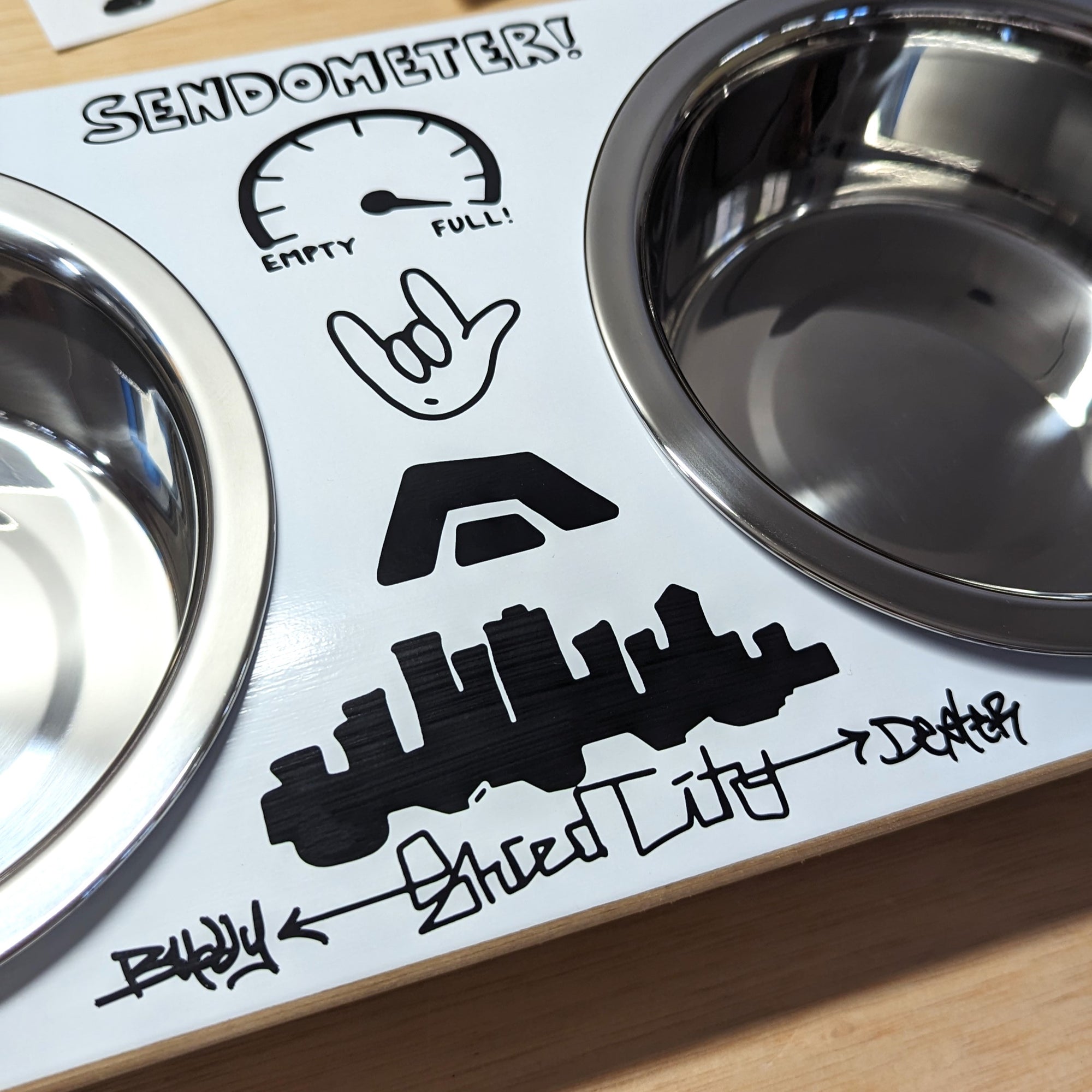 Skateboard dog bowl feeder stand handcrafted with custom designed art.