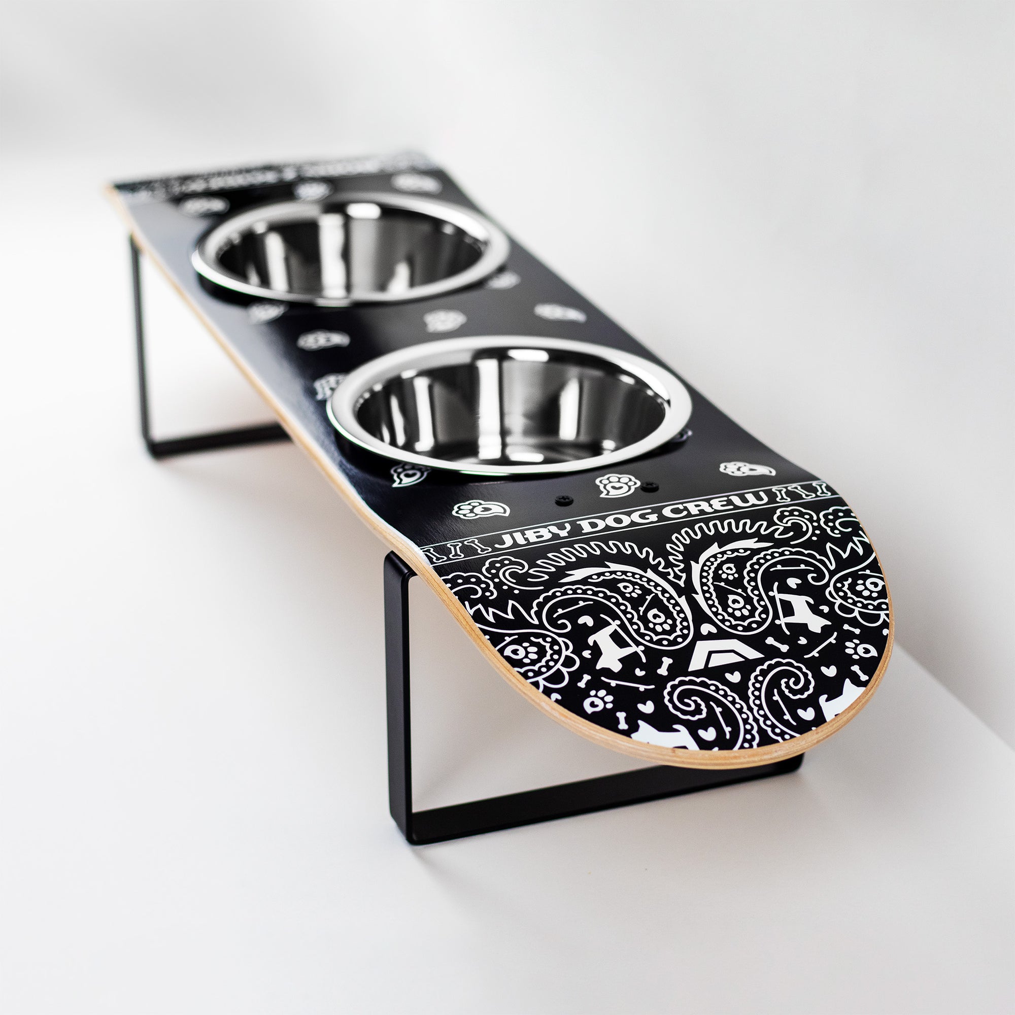 Skateboard dog bowl feeder stand handcrafted with custom designed art.