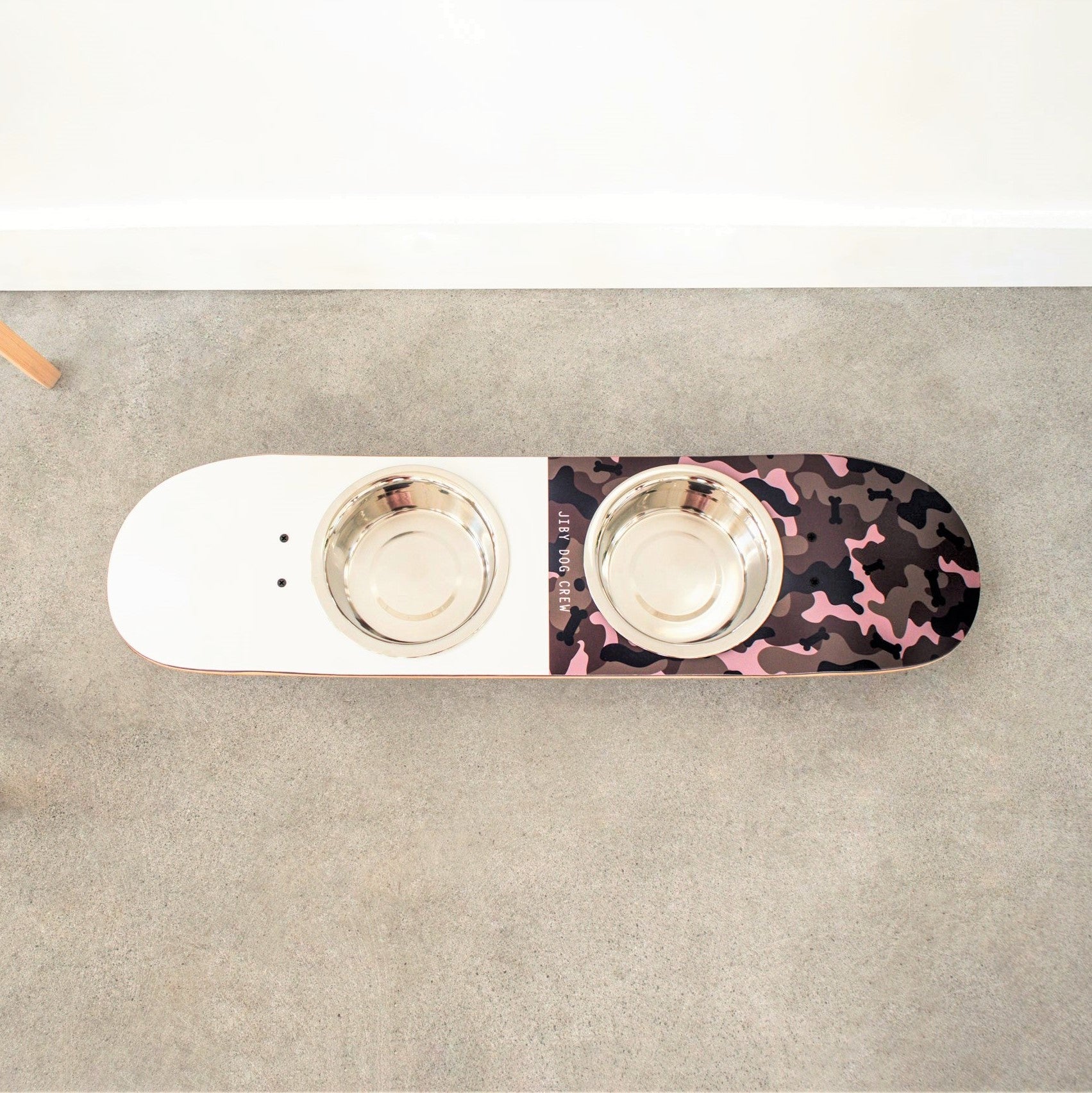 Skateboard dog bowl feeder stand handcrafted with custom designed art.