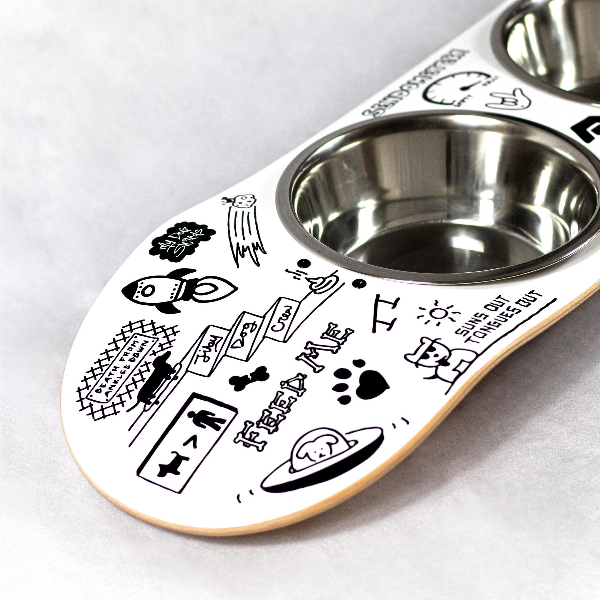 Skateboard dog bowl feeder stand handcrafted with custom designed art.