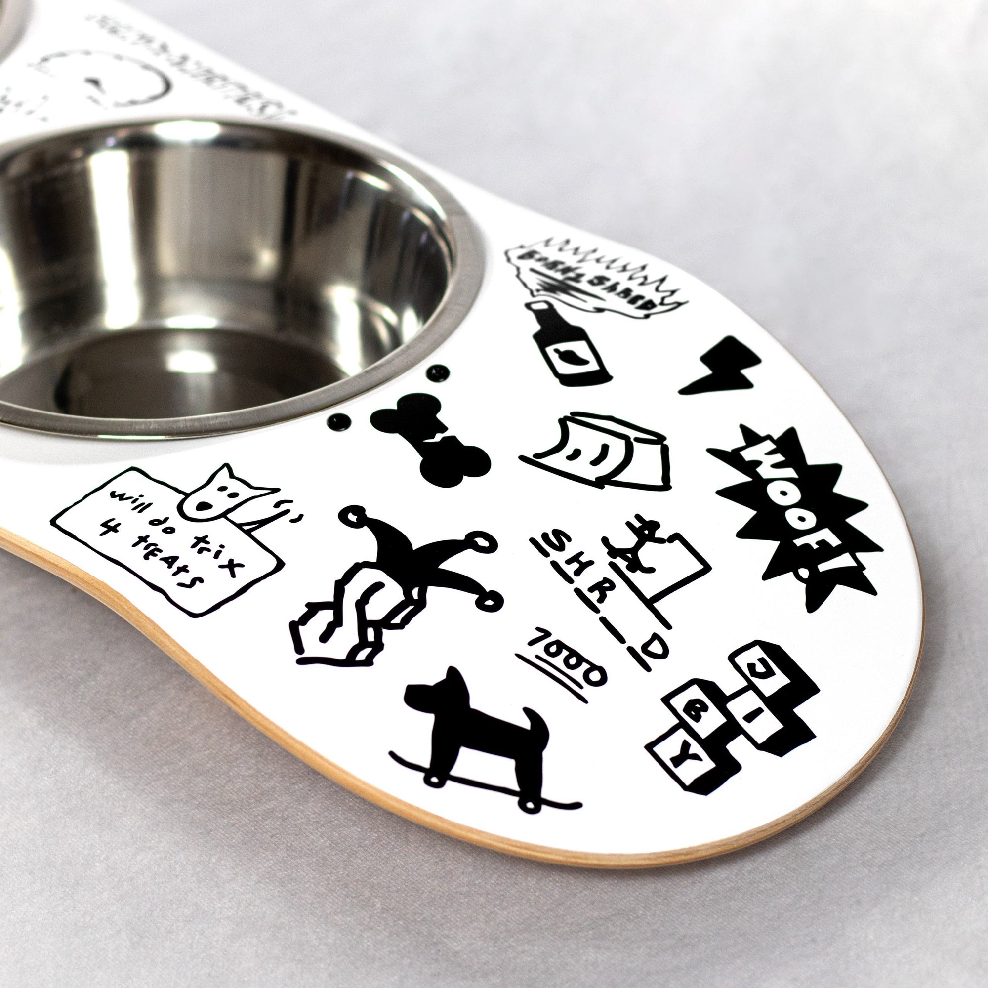 Skateboard dog bowl feeder stand handcrafted with custom designed art.